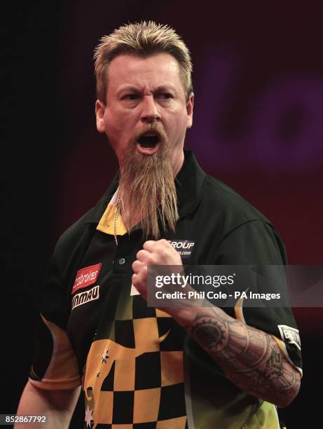 Simon Whitlock celebrates a 180 against Kevin Painter during the third round match,during day twelve of The Ladbrokes World Darts Championship at...