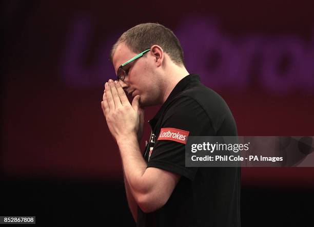 Mark Webster misses a chance against Raymond van Barneveld during the third round match,during day twelve of The Ladbrokes World Darts Championship...