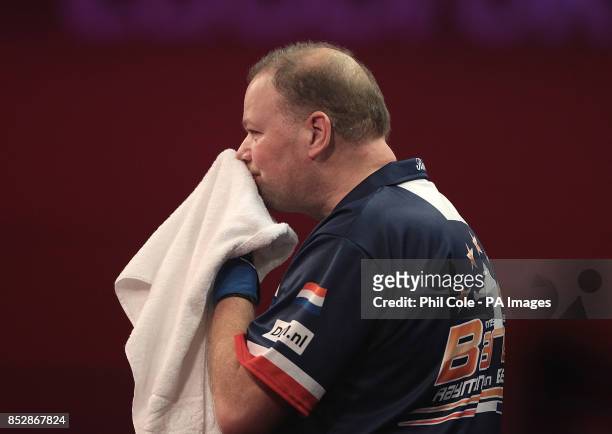 Raymond van Barneveld wipes his face after losing to Mark Webster during the third round match,during day twelve of The Ladbrokes World Darts...