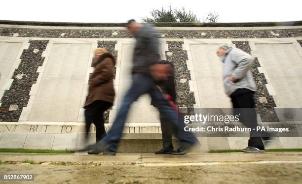 People walk past the memorial wall at Tyne Cot Cemetery and Memorial Ypres, Belgium. The centenary of the outbreak of the First World War next year...