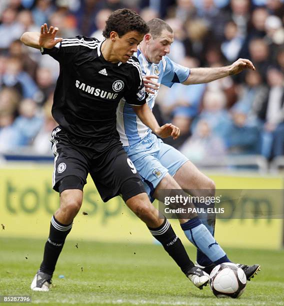 Chelsea's Argentinian forward Franco Di Santo is challenged by Coventry City's English defender Stephen Wright during their English FA Cup sixth...