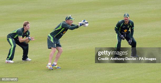 Australia's Steven Smith and Michael Clarke look-on as Brad Haddin takes a catch during the nets session at the Sydney Cricket Ground, Australia.