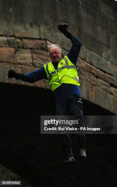 Charity competitor Gerald Sargent jumps 30ft off of Mapleton Bridge into the River Dove during The Mapleton boat race and bridge jump, at Mapleton,...