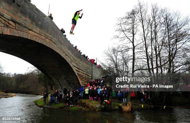 Charity competitor jumps 30ft off of Mapleton Bridge into the River Dove during The Mapleton boat race and bridge jump, at Mapleton, near Ashbourne,...