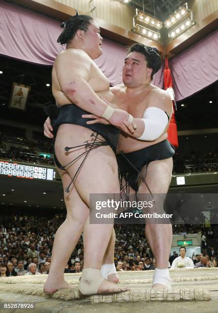 Mongolian yokozuna, or grand champion, Harumafuji pushes out ozeki-ranked Goeido of Japan during a playoff bout on the final day of the 15-day Autumn...