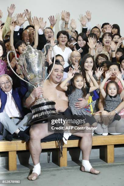 Mongolian yokozuna, or grand champion, Harumafuji celebrates his victory with supporters after the end of the 15-day Autumn Grand Sumo Tournament in...