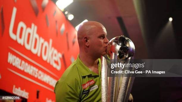 Michael Van Gerwen kisses the Sid Waddell trophy after winning the Final of The Ladbrokes World Darts Championship at Alexandra Palace, London.