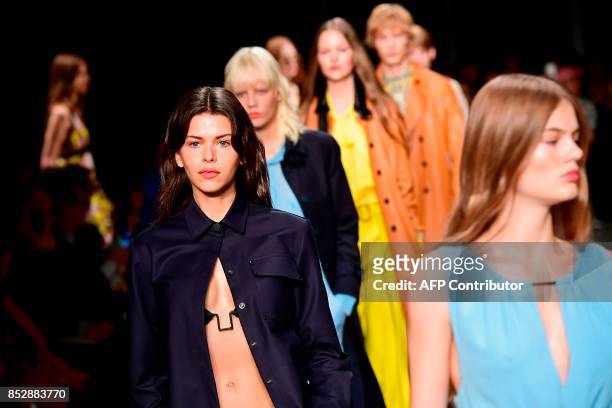Models present creations for fashion house Trussardi during the Women's Spring/Summer 2018 fashion shows in Milan, on September 24, 2017. / AFP PHOTO...