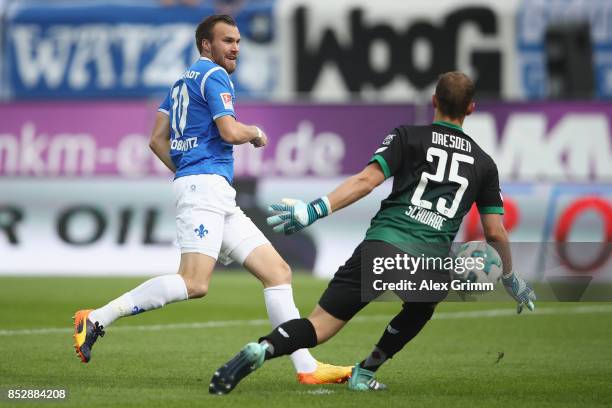 Goalkeeper Marvin Schwaebe of Dresden makes a save against Kevin Grosskreutz of Darmstadt during the Second Bundesliga match between SV Darmstadt 98...