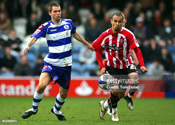 Matthew Connolly of Queens Park Rangers and Danny Webber of Sheffield United chase the ball during the Coca Cola Championship match between Queens...