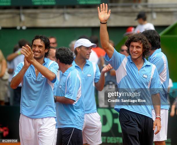 Martin Vasallo Arguello and Juan Monaco beckons to the public after winning the double match against Netherland's tennis players Jesse Huta Galung...