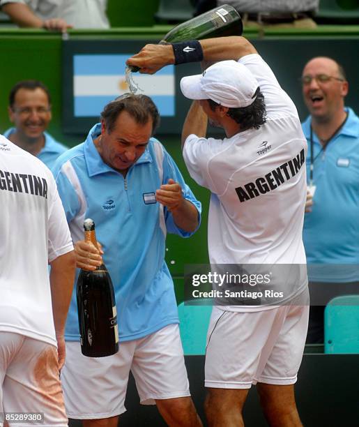 Martin Vasallo Arguello celebrates with Argentina's coach Modesto Vasquez after winning the double match against Netherland's tennis players Jesse...