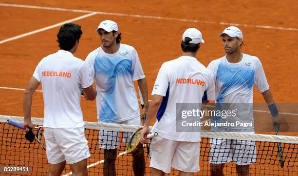 Lucas Arnold and Martin Vasallo Arguello of Argentina shake hands with Jesse Huta Galung and Rogier Wassen of the Netherlands during their day 2...