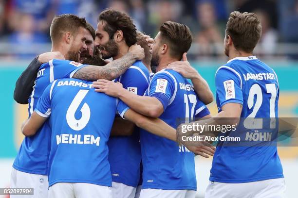 Tobias Kempe of Darmstadt celebrates his team's first goal with team mates and head coach Torsten Frings during the Second Bundesliga match between...