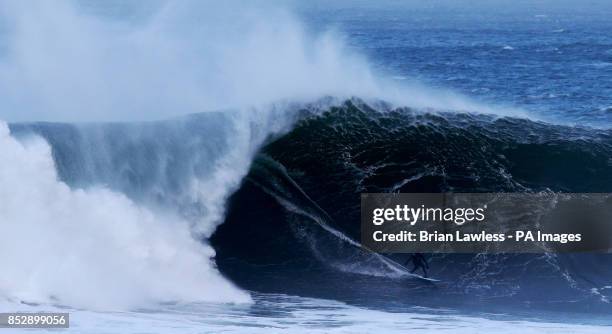 Surfer rides a wave at Mullaghmore, Co. Sligo.