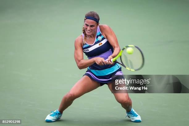 Monica Puig of Puerto Rico returns a shot during the match against Mona Barthel of Germany on Day 1 of 2017 Dongfeng Motor Wuhan Open at Optics...