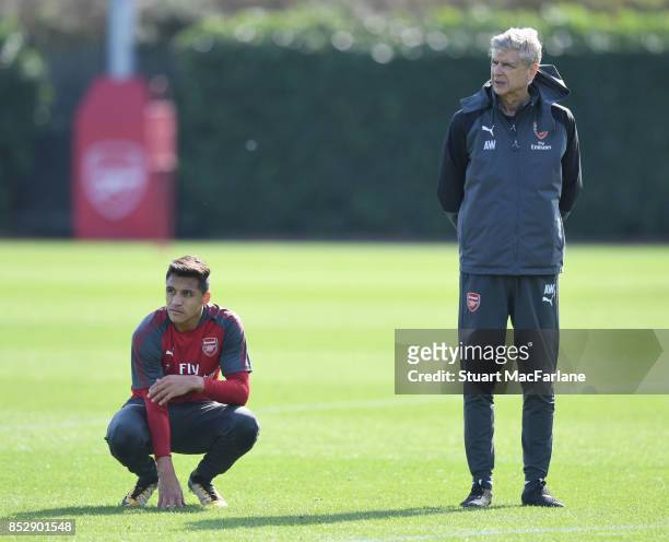 Arsenal manager Arsene Wenger and Alexis Sanchez during a training session at London Colney on September 24, 2017 in St Albans, England.