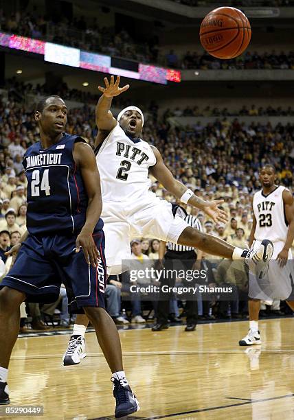 Levance Fields of the Pittsburgh Panthers passes around Craig Austrie of the Connecticut Huskies on March 7, 2009 at the Petersen Events Center in...