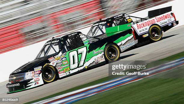 Chad McCumbee, driver of the ASI Limited Chevrolet, races Bryan Silas, driver of the Rockingham Speedway Chevrolet, during the NASCAR Craftsman Truck...