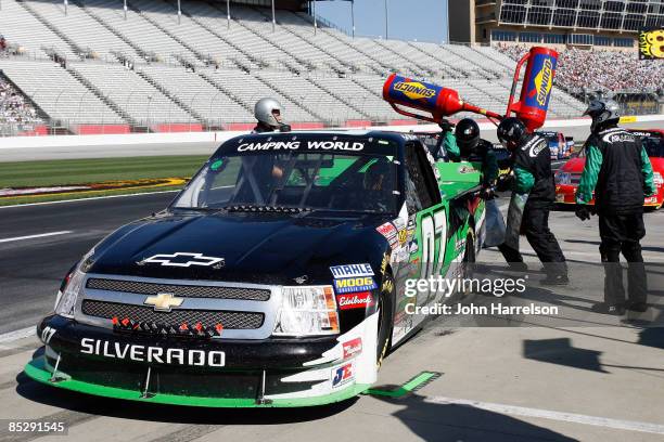 Chad McCumbee driver of the ASI Limited Chevrolet makes a pit stop during the NASCAR Craftsman Truck Series American Commercial Lines 200 at the...