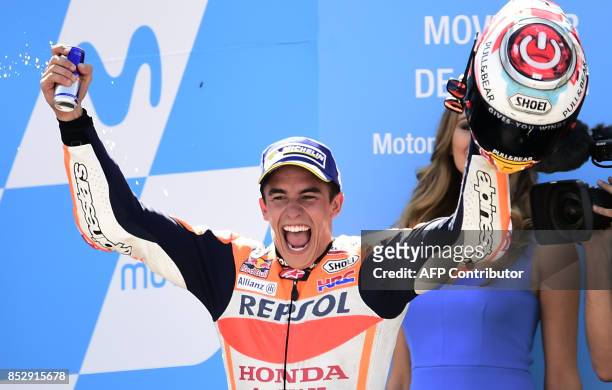 Repsol Honda Team's Spanish rider Marc Marquez celebrates on the podium winning the MOTO GP race of the Moto Grand Prix of Aragon at the Motorland...