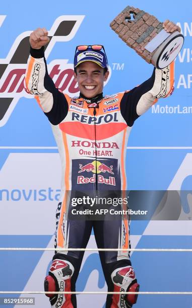 Repsol Honda Team's Spanish rider Marc Marquez celebrates on the podium winning the MOTO GP race of the Moto Grand Prix of Aragon at the Motorland...