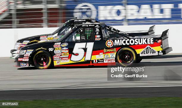 Kyle Busch, driver of the Miccosukee Toyota, races Chad McCumbee, driver of the ASI Limited Chevrolet, during the NASCAR Craftsman Truck Series...