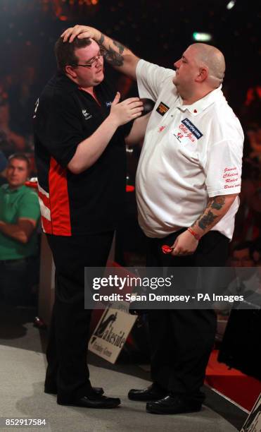 Stephen Bunton is congratulated by Robbie Green after winning their semi-final during the BDO World Championships at the Lakeside Complex, Surrey.