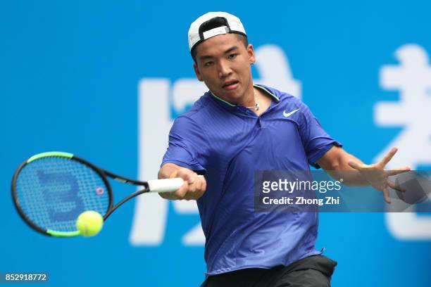 Zihao Xia of China returns a shot during the match against Mate Pavic of Croatia during Qualifying second round of 2017 ATP Chengdu Open at Sichuan...