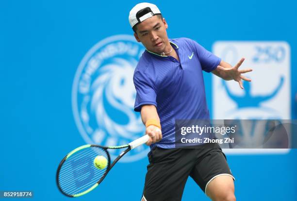 Zihao Xia of China returns a shot during the match against Mate Pavic of Croatia during Qualifying second round of 2017 ATP Chengdu Open at Sichuan...