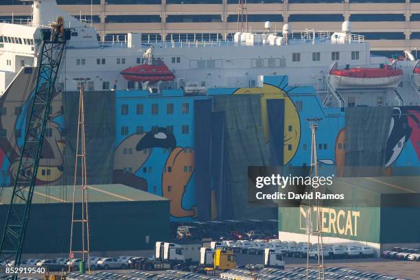 Spanish Police vans are parked next to a ferry ship, rented by the Spanish Interior Ministry to house National Police and Civil Guard police...