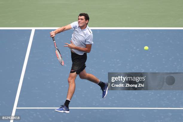 Taylor Fritz of the United States returns a shot during the match against Marco Chiudinelli of Switzerland during Qualifying second round of 2017 ATP...