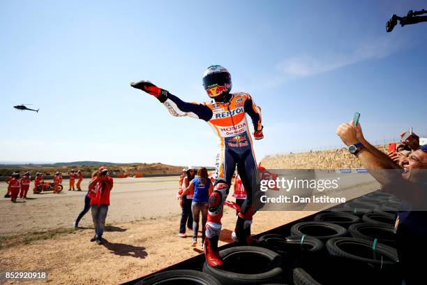 Marc Marquez of Spain and the Repsol Honda Team celebrates victory with his fans by the side of the track after the MotoGP of Aragon at Motorland...