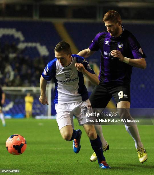 Birmingham City's Shane Ferguson holds off a challenge from Bristol Rovers's Matt Harrold during the FA Cup, Third Round Replay match at St Andrews,...