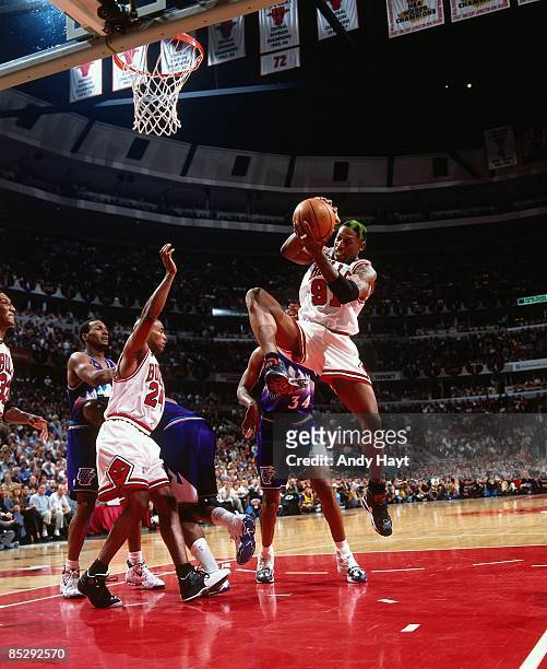 Dennis Rodman of the Chicago Bulls rebounds during Game Four of the 1998 NBA Finals against the Utah Jazz played on June 10, 1998 at the United...