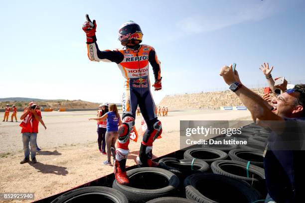 Marc Marquez of Spain and the Repsol Honda Team celebrates victory with his fans by the side of the track after the MotoGP of Aragon at Motorland...