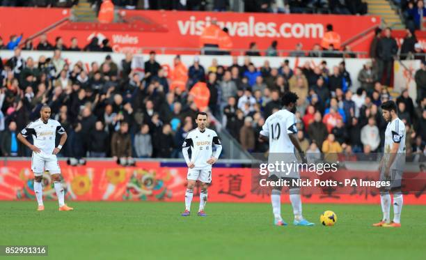 Swansea City's Alejandro Pozuelo , Leon Britton Wilfried Bony and Ashley Williams stand dejected waiting to restart the match after Tottenham...