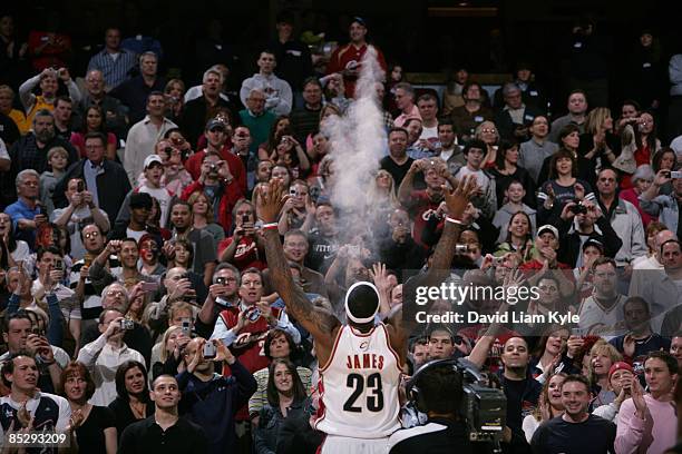 LeBron James of the Cleveland Cavaliers tosses talc high into the air prior to the game against the Miami Heat at The Quicken Loans Arena on March 7,...