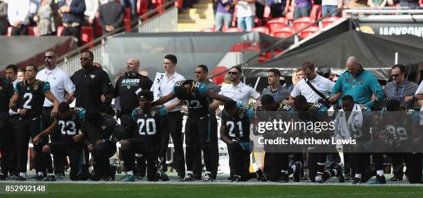Jacksonville Jaguar players show their protest during the National Anthem during the NFL International Series match between Baltimore Ravens and...