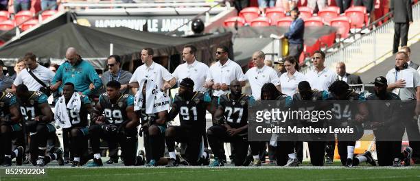 Jacksonville Jaguar players show their protest during the National Anthem during the NFL International Series match between Baltimore Ravens and...