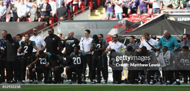 Jacksonville Jaguar players show their protest during the National Anthem during the NFL International Series match between Baltimore Ravens and...