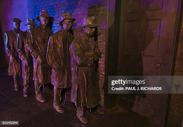 The bronze scupture created by George Segal, "Depression Bread Line", shows five men waiting in line near a door during the Great Depression and the...