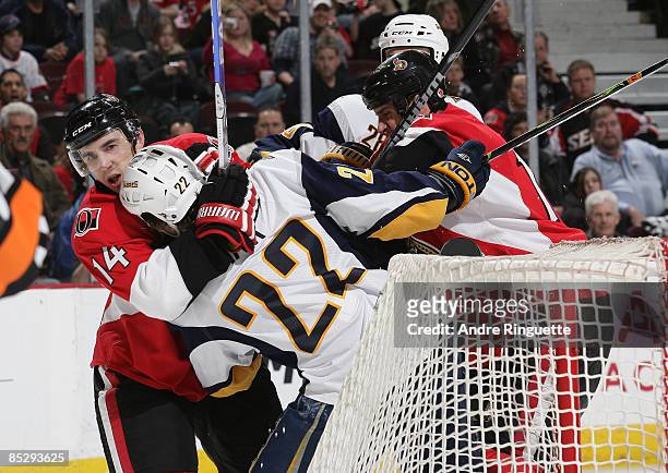 Chris Campoli of the Ottawa Senators grabs a hold of Adam Mair of the Buffalo Sabres with a head lock after a scrum at Scotiabank Place on March 7,...