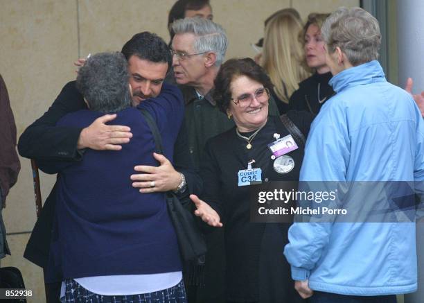 Relatives of the victims that were killed in the Pan Am Flight 103 bombing over Lockerbie, Scotland, congratulate and hug each other at the entrance...