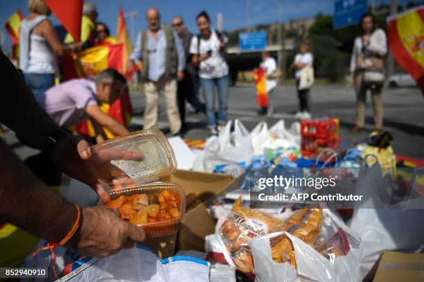 People carrying Spanish flags gather at Barcelona's port with food and drinks for Spanish National Police and Guardia Civil officers, who are housed...