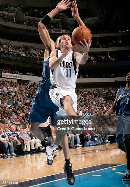 Jose Juan Barea of the Dallas Mavericks goes up and under against JaVale McGee of the Washington Wizards on March 7, 2009 at the American Airlines...