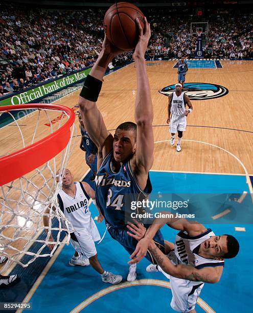 JaVale McGee of the Washington Wizards goes up for the dunk against Gerald Green of the Dallas Mavericks on March 7, 2009 at the American Airlines...