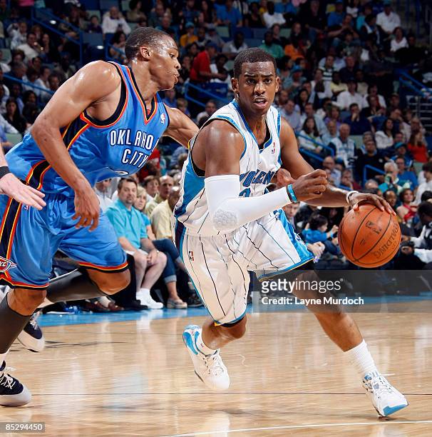 Chris Paul of the New Orleans Hornets drives past Russell Westbrook of the Oklahoma City Thunder on March 7, 2009 at the New Orleans Arena in New...