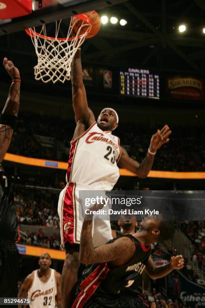 LeBron James of the Cleveland Cavaliers goes up for the layup defended by Dorell Wright of the Miami Heat at The Quicken Loans Arena on March 7, 2009...