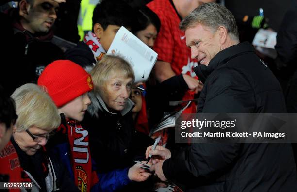 Manchester United manager David Moyes signs autographs for fans before the Capital One Cup, Semi Final, Second Leg at Old Trafford, Manchester.